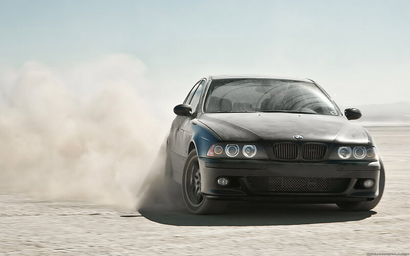 Black BMW drifting on desert