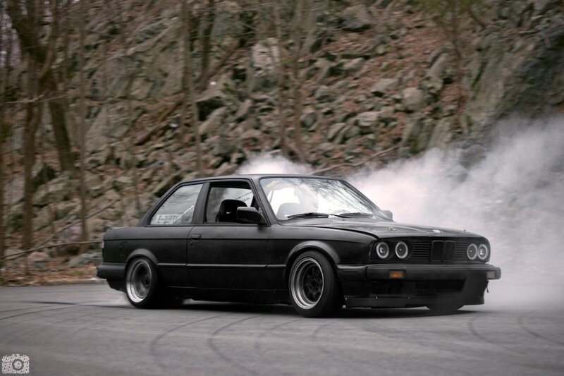 Black BMW drifting on road