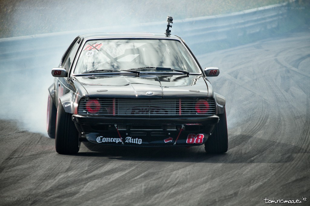 Black BMW drifting on track