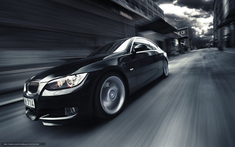 Black BMW driving fast on street