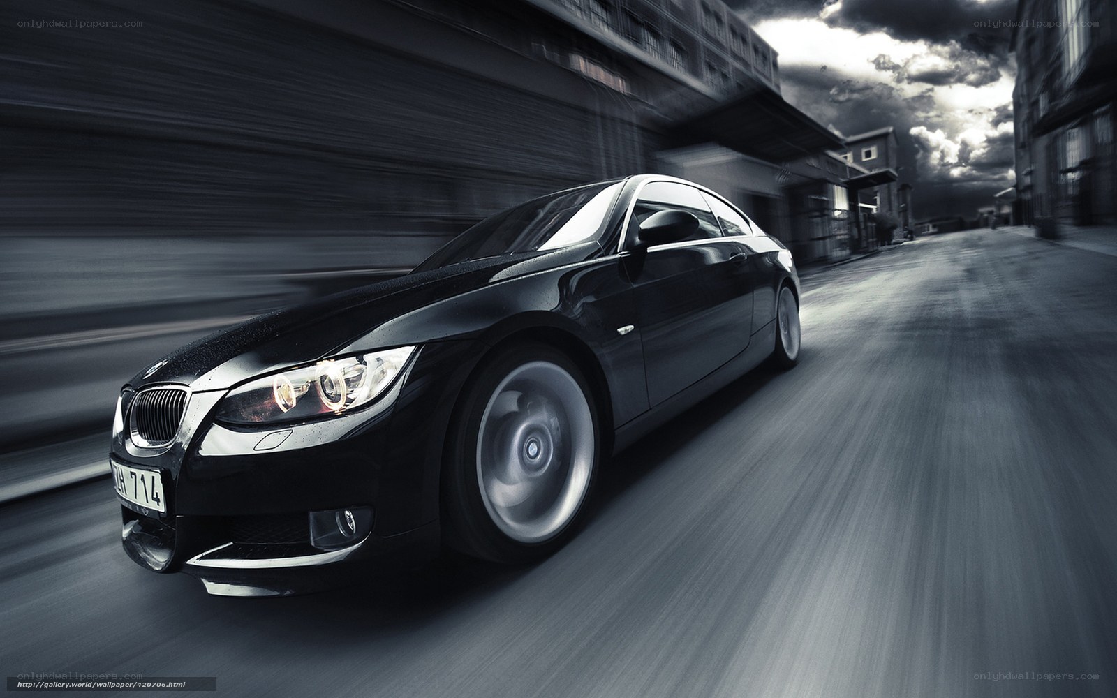 Black BMW driving fast on street
