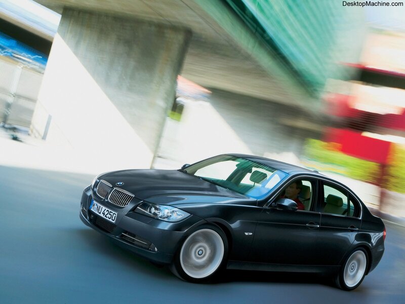 Black BMW driving on a road