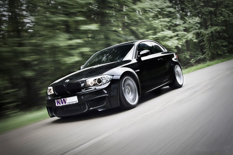 Black BMW driving on a road