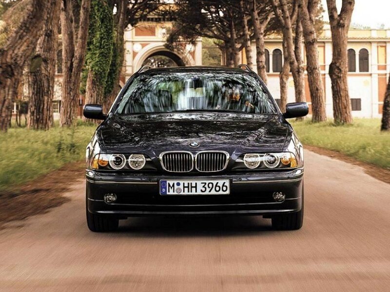 black bmw driving on a road