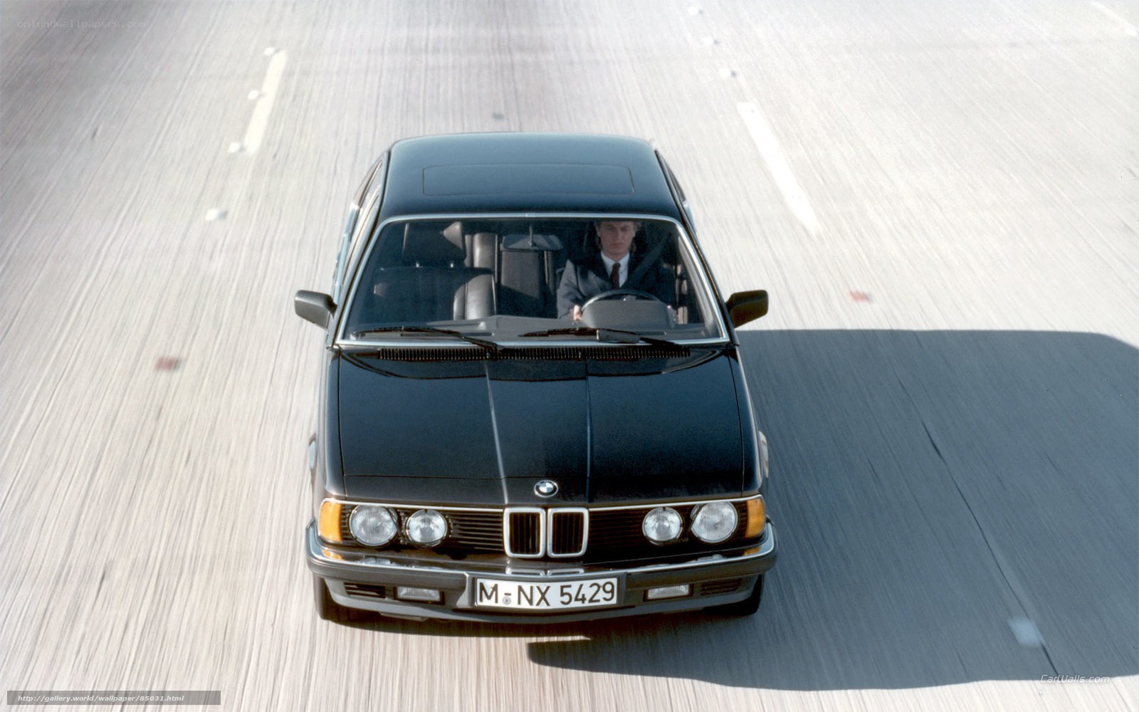 black bmw driving on highway