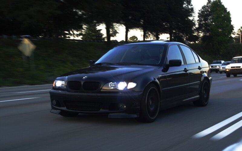 black bmw driving on road
