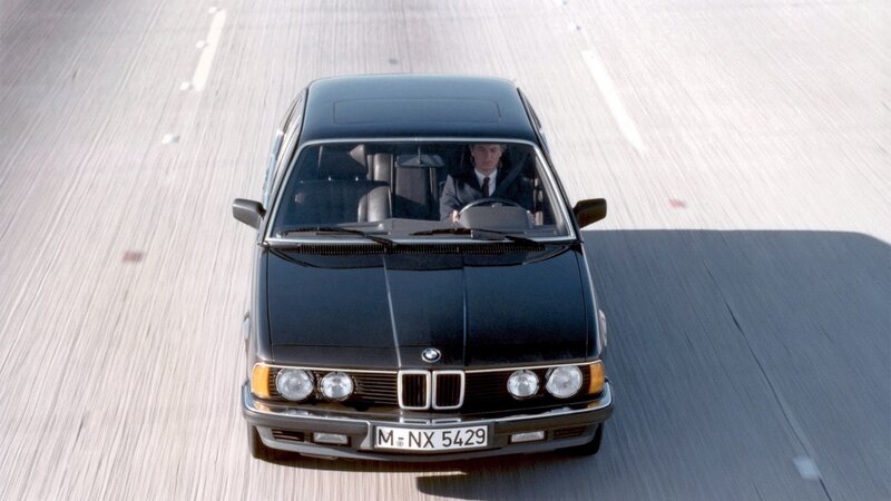 black bmw driving on road