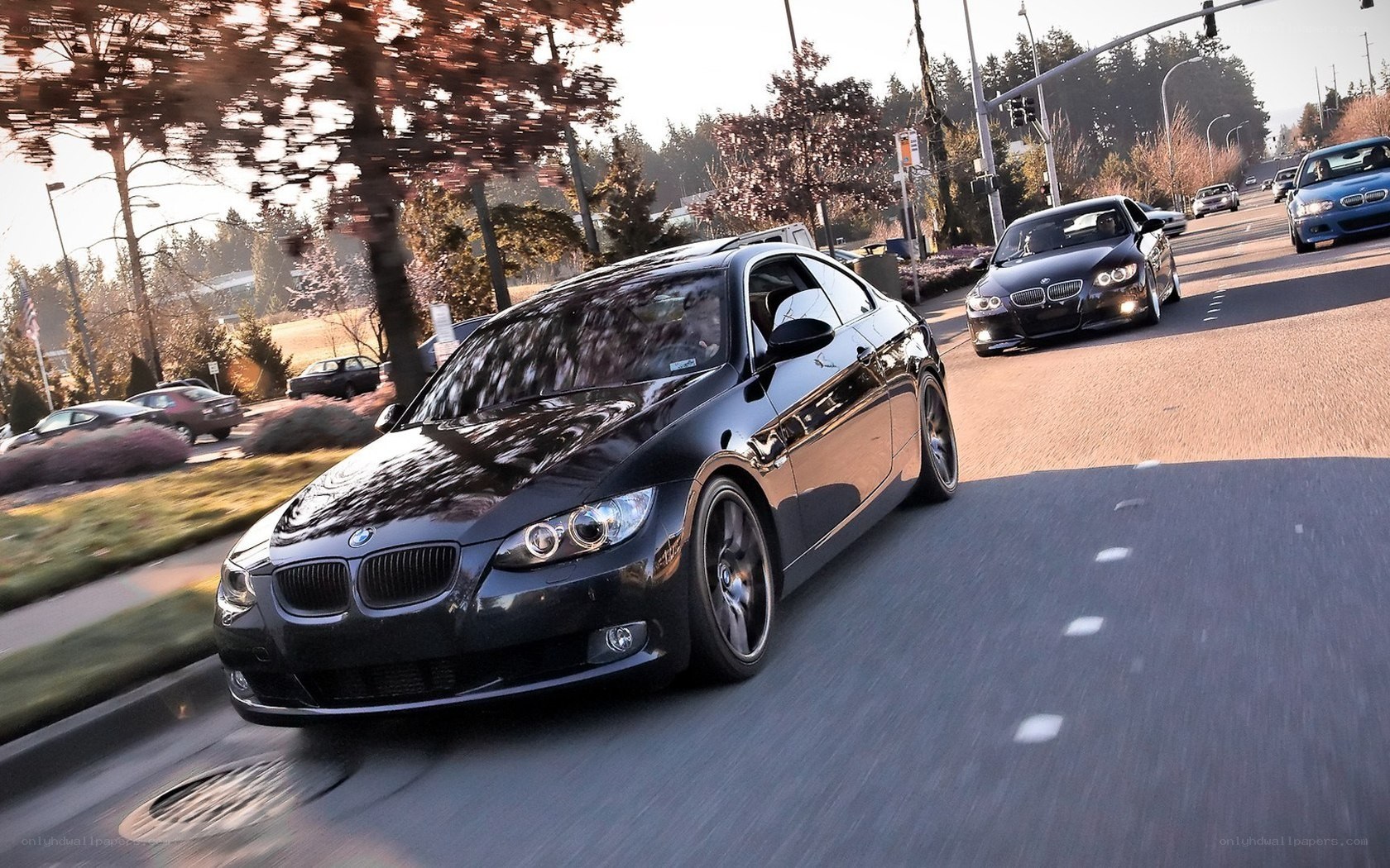 Black BMW driving on road