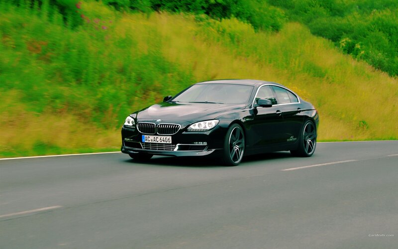 black bmw driving on road