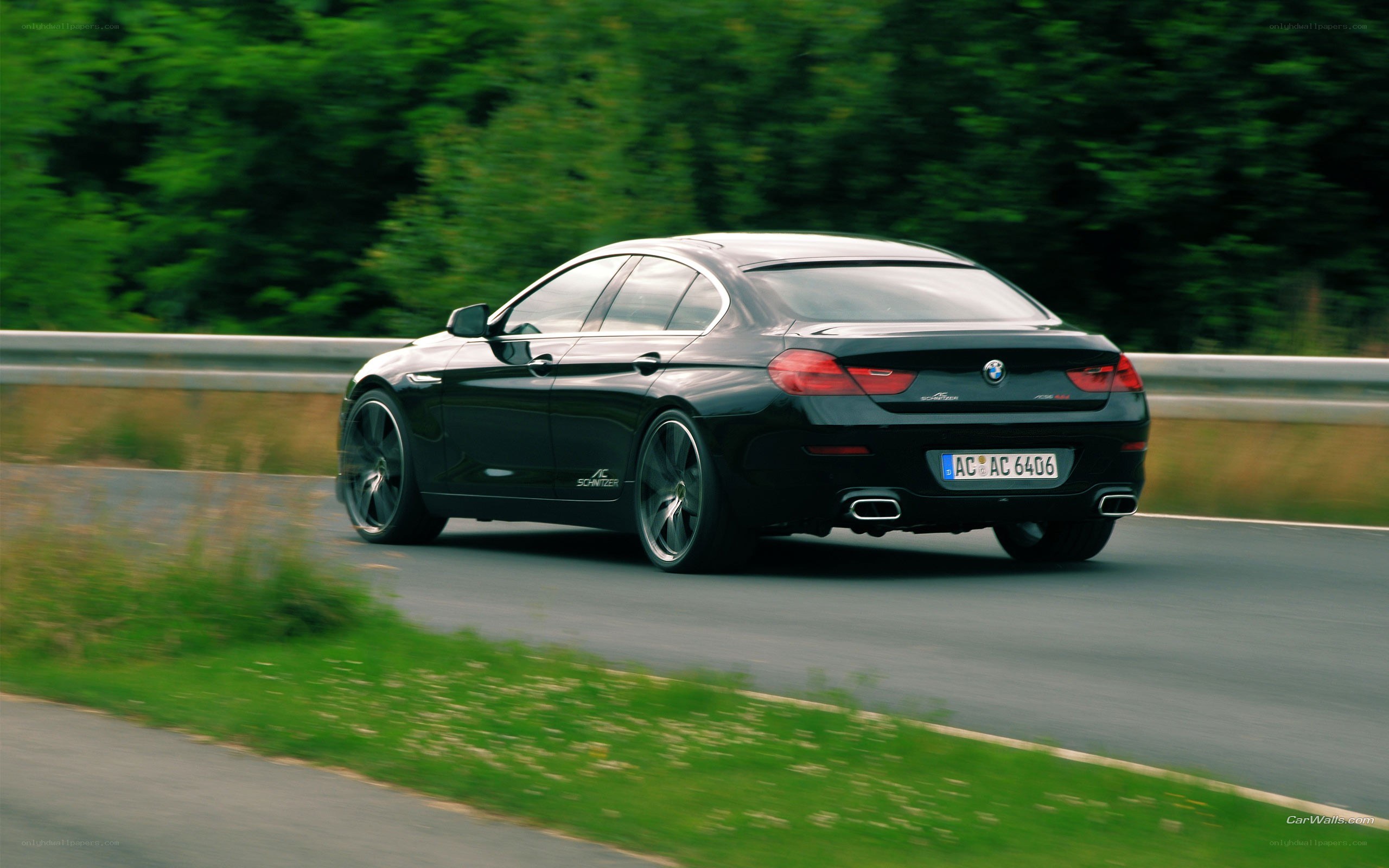 black bmw driving on road