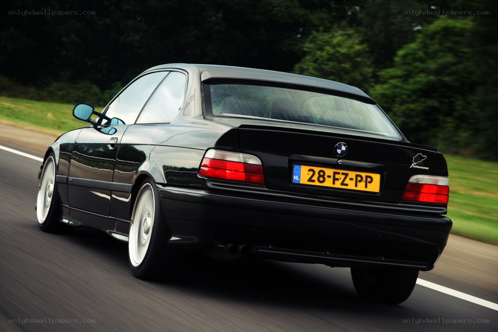 black bmw driving on road