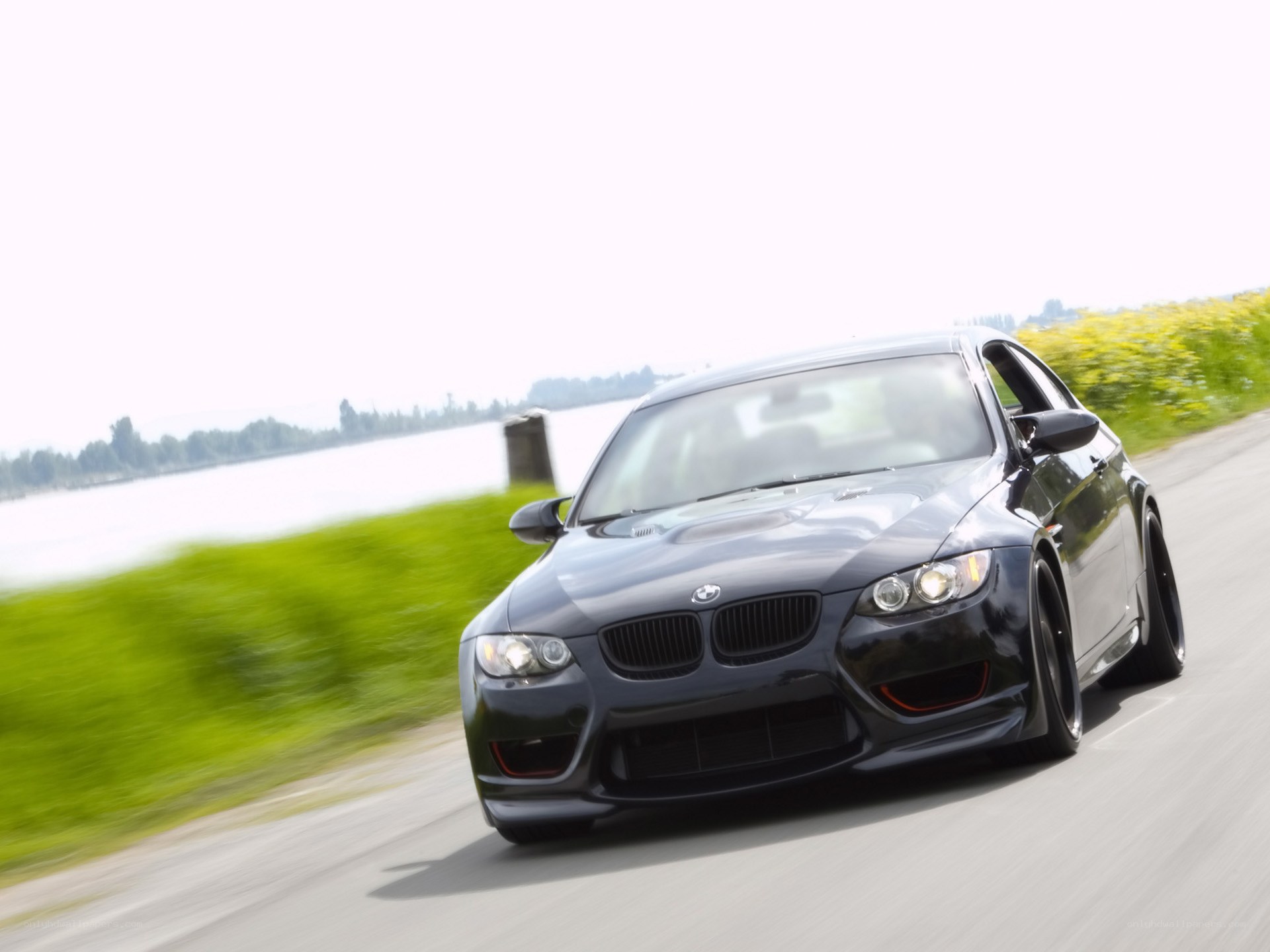 Black BMW driving on road