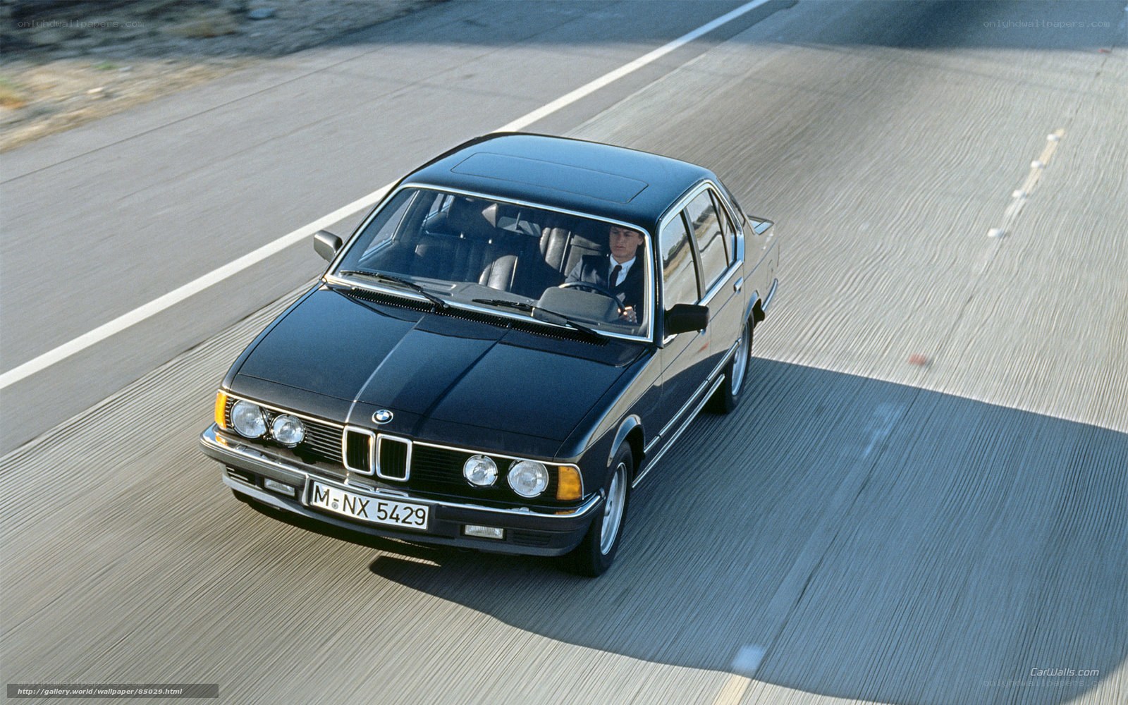 black bmw driving on road