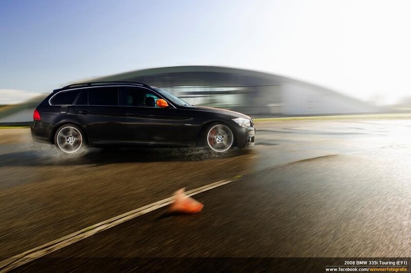 Black BMW driving on track