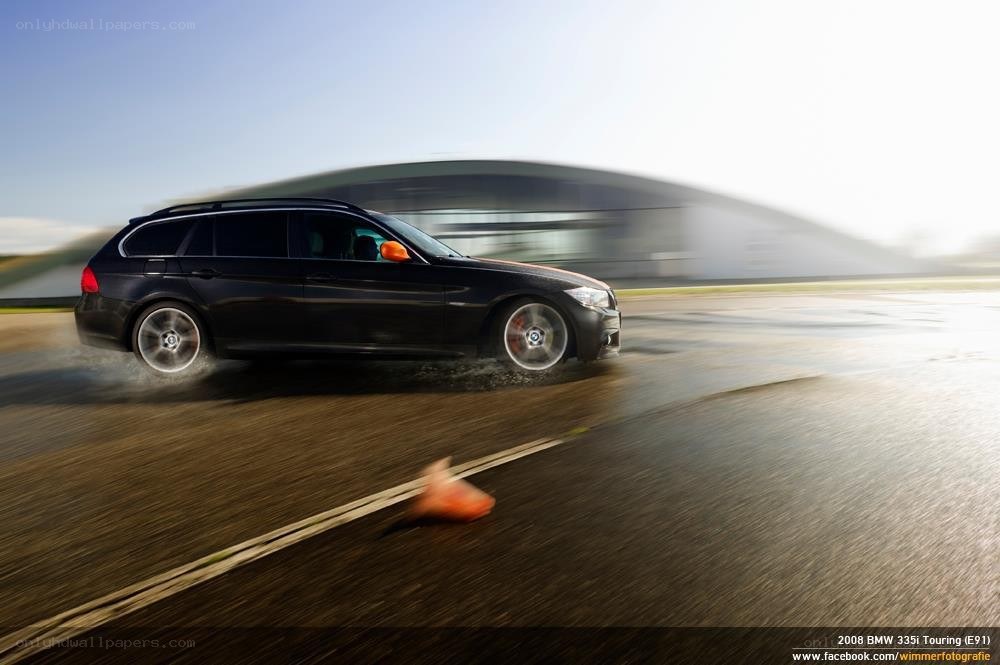 Black BMW driving on track