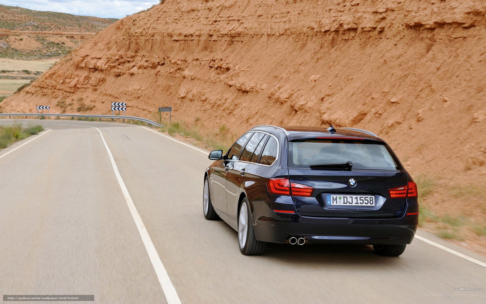 black bmw driving on winding road