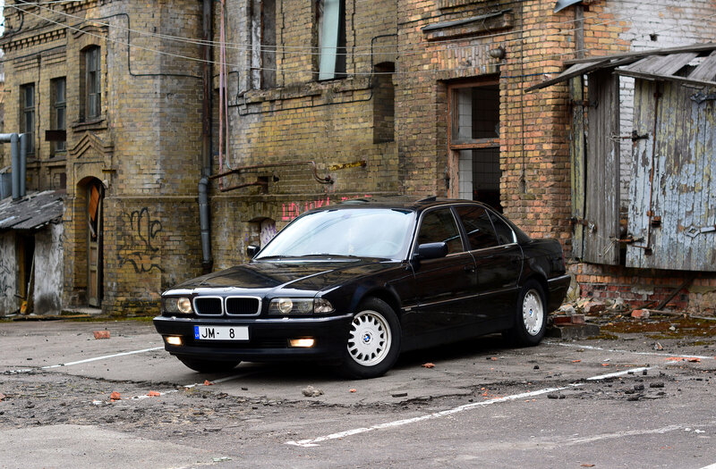 Black BMW in an urban alley