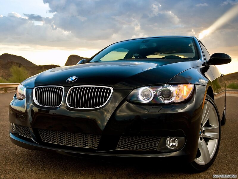 Black BMW in desert sunset