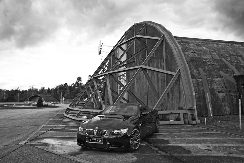 Black BMW in front of hangar