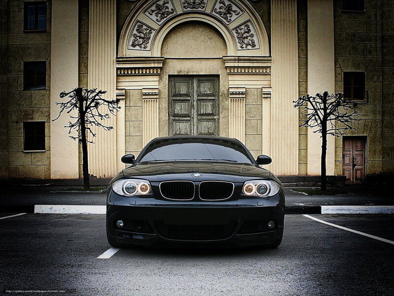 Black BMW in front of old building
