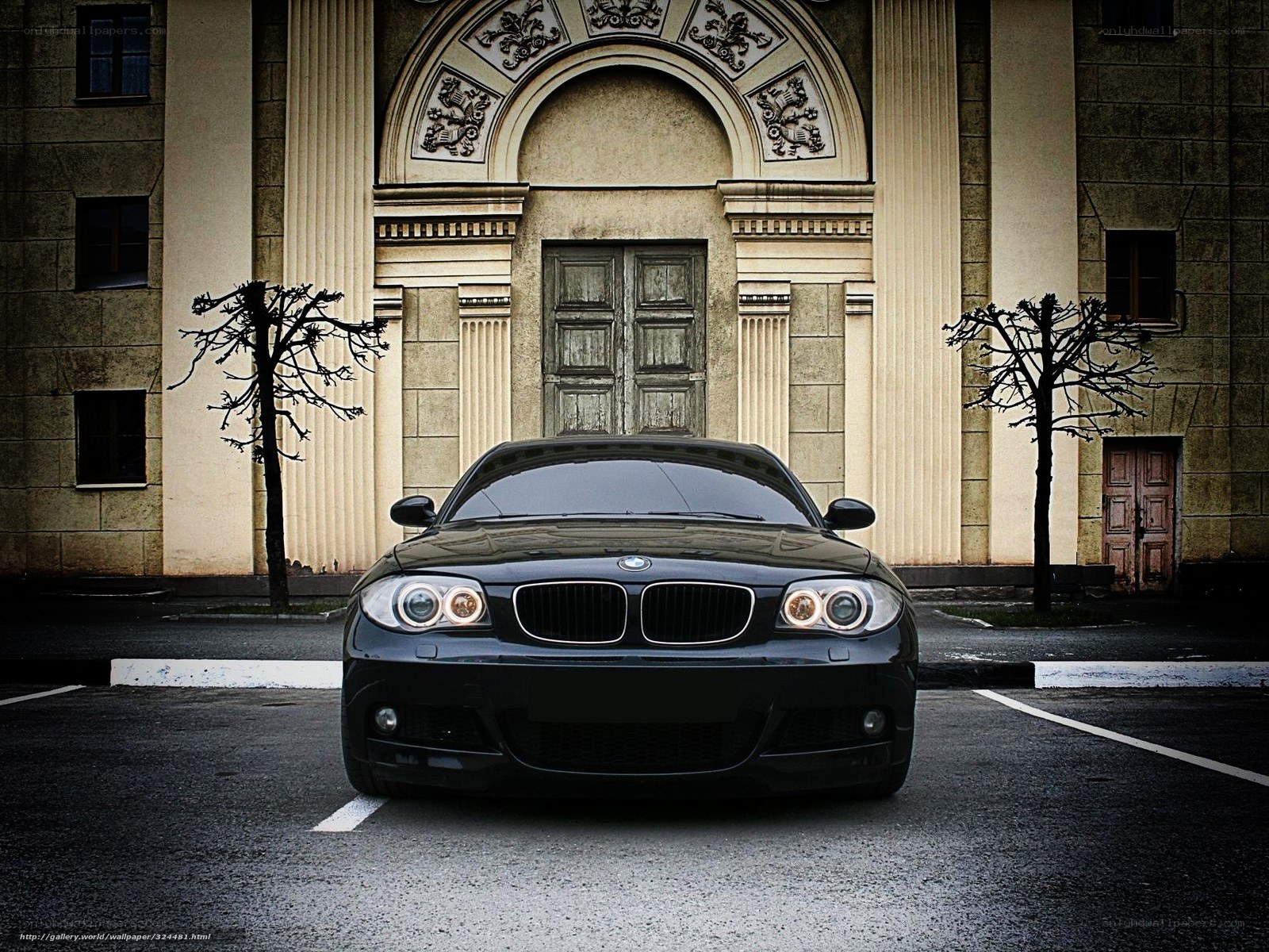 Black BMW in front of old building