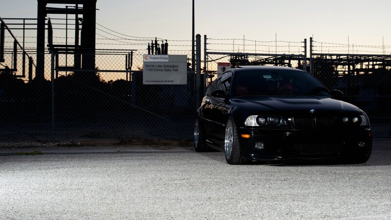 Black BMW in front of substation