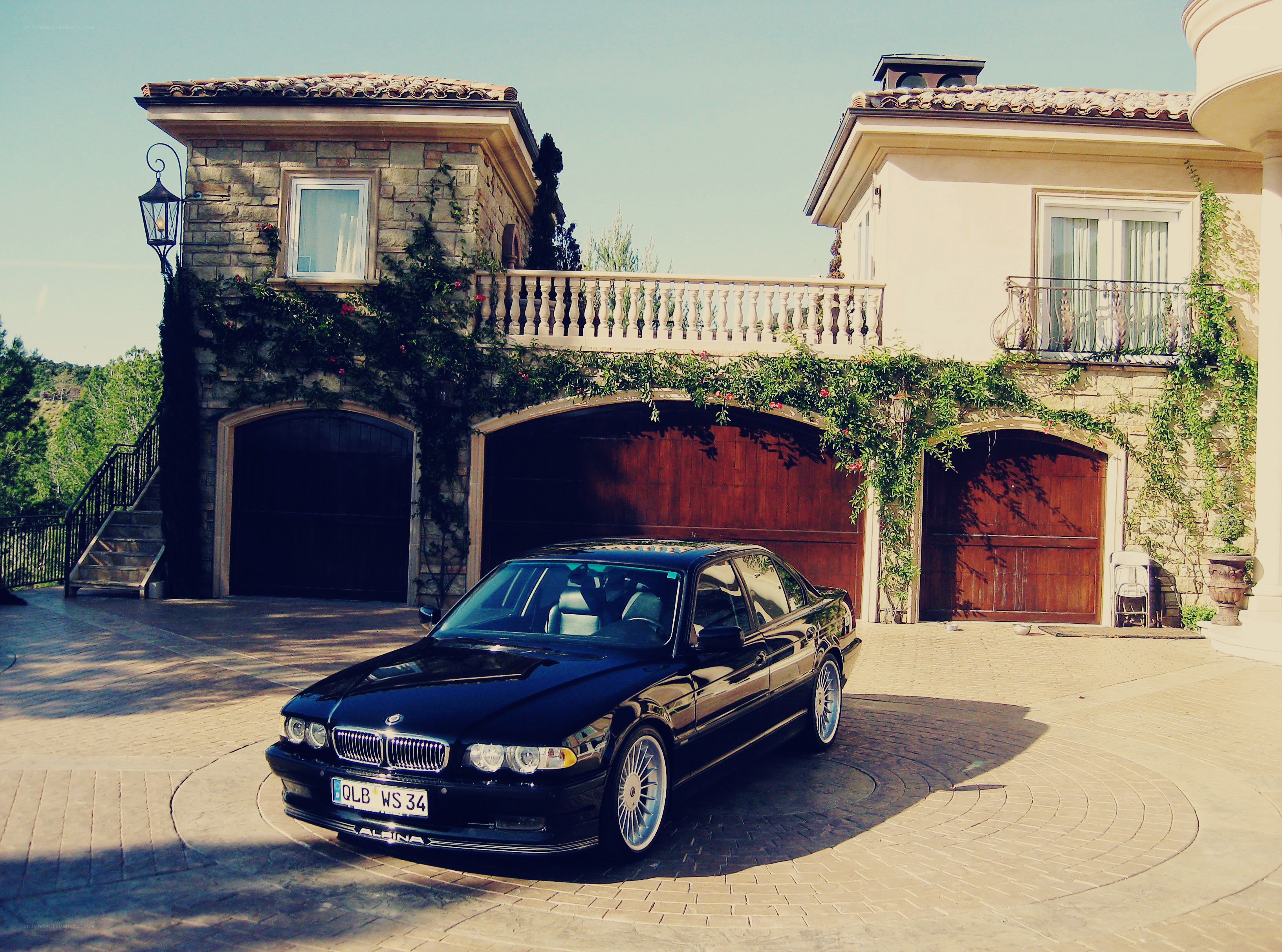 Black BMW in front of villa