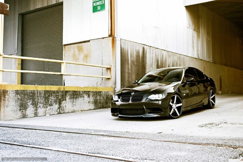 Black BMW in industrial alley