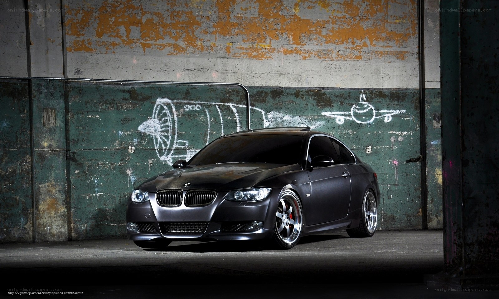 Black BMW in industrial setting