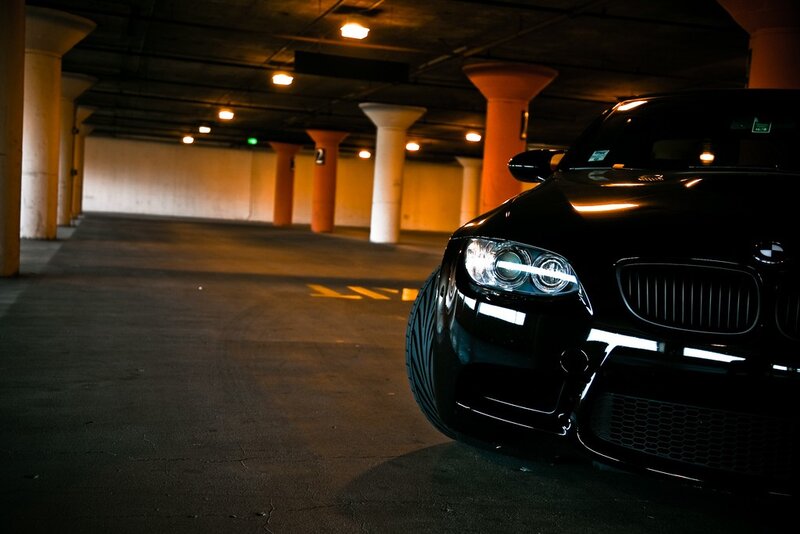 Black BMW in parking garage