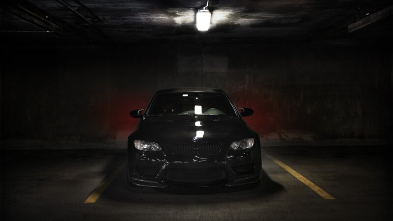 Black BMW in parking garage