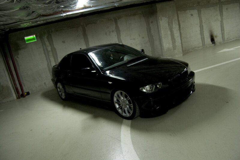 Black BMW in parking garage