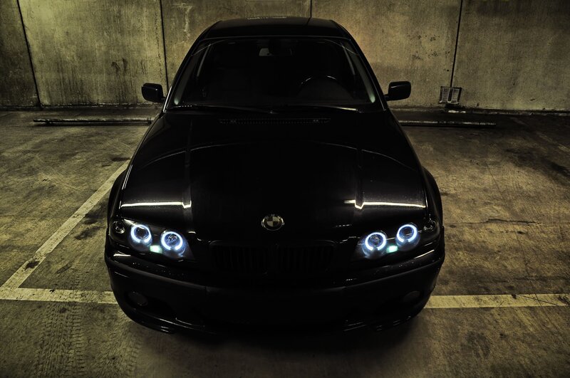Black BMW in parking garage