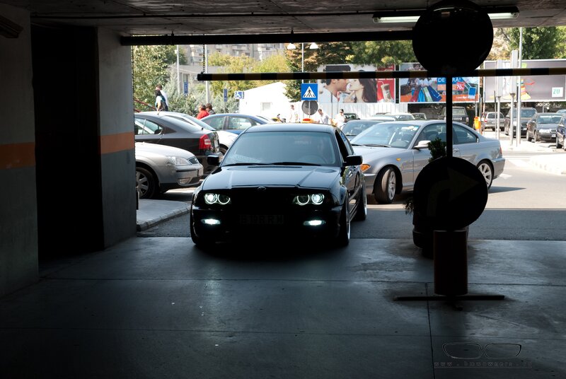 Black BMW in parking garage