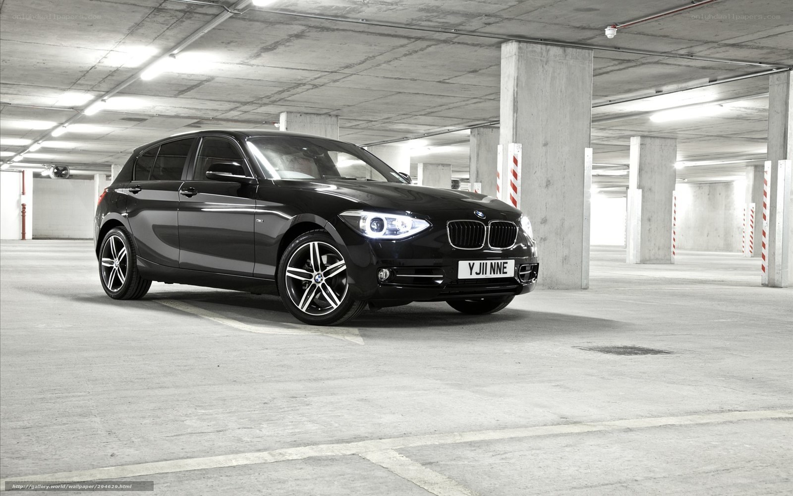 Black BMW in parking garage