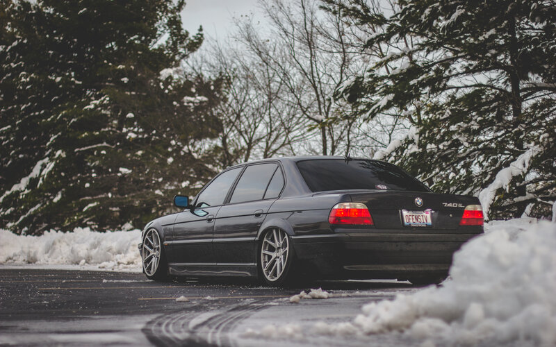 Black BMW in snowy parking lot