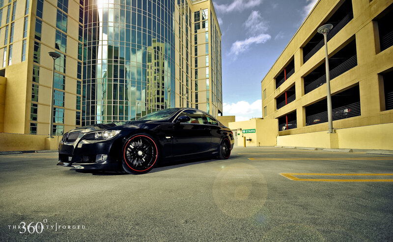Black BMW in urban parking lot