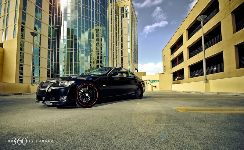 Black BMW in urban parking lot
