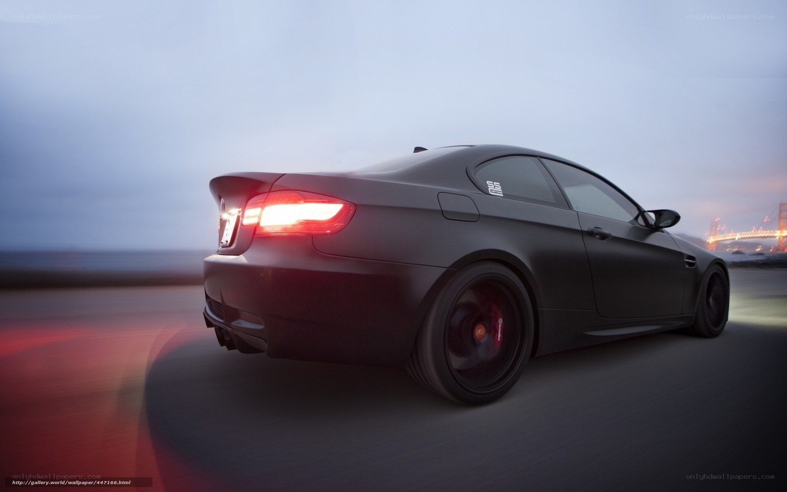 black bmw m3 driving at dusk