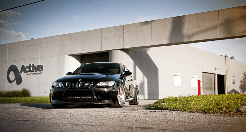 Black BMW M3 in front of building