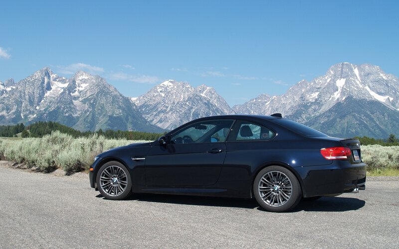 Black BMW M3 in mountain landscape