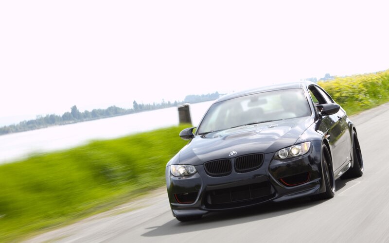 black bmw m3 on a country road