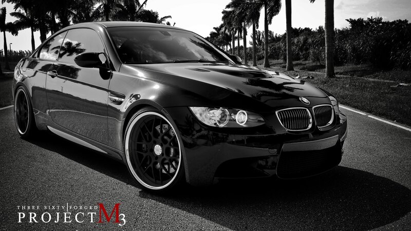 Black BMW M3 on a palm-lined road