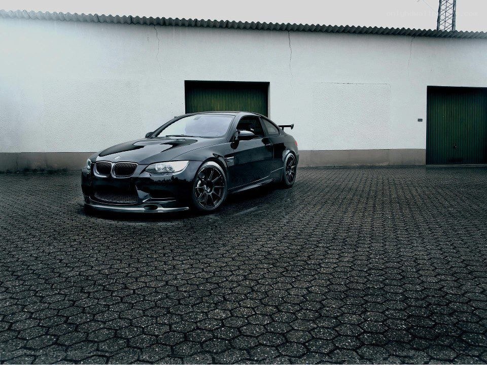 Black BMW M3 on cobblestone