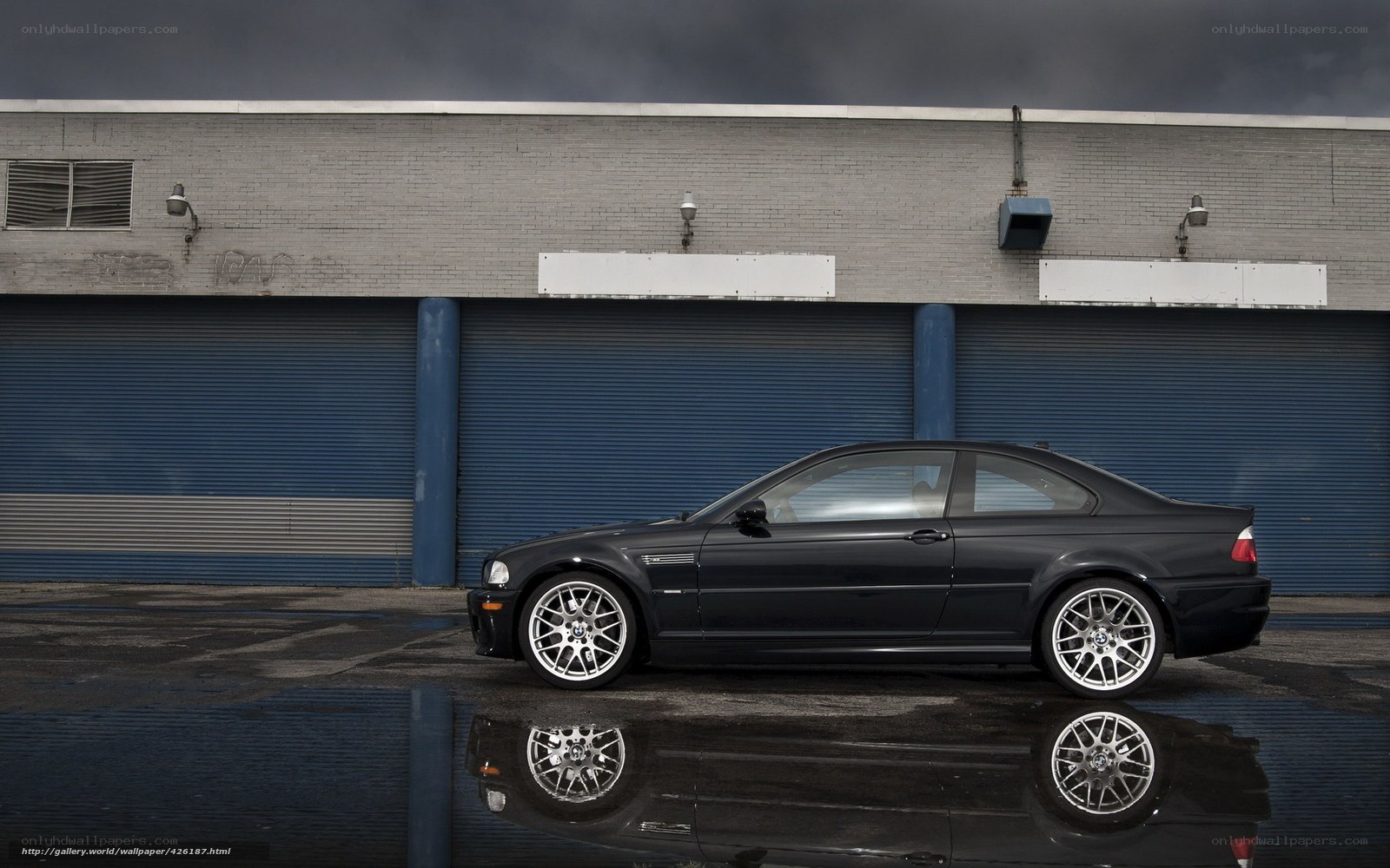 Black BMW M3 on wet pavement