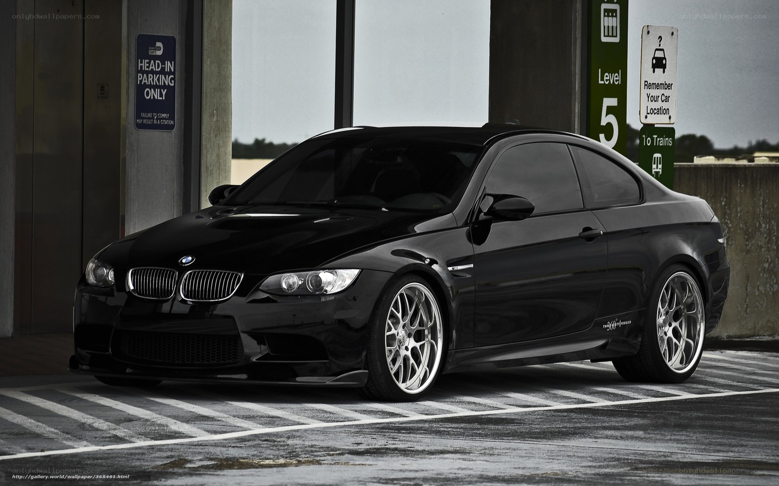 Black BMW M3 parked in garage