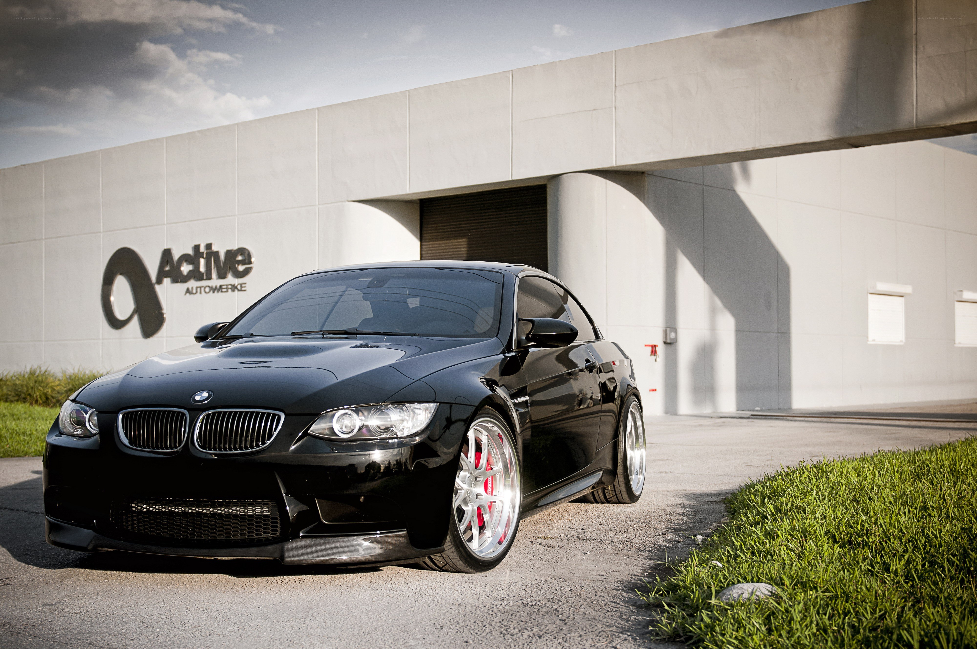 Black BMW M3 parked outside building