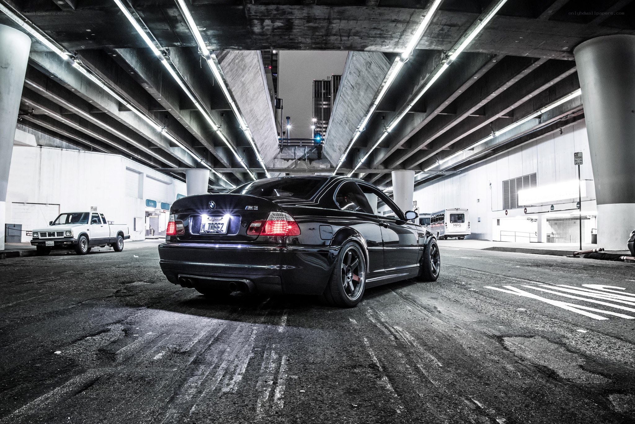 Black BMW M3 under an overpass