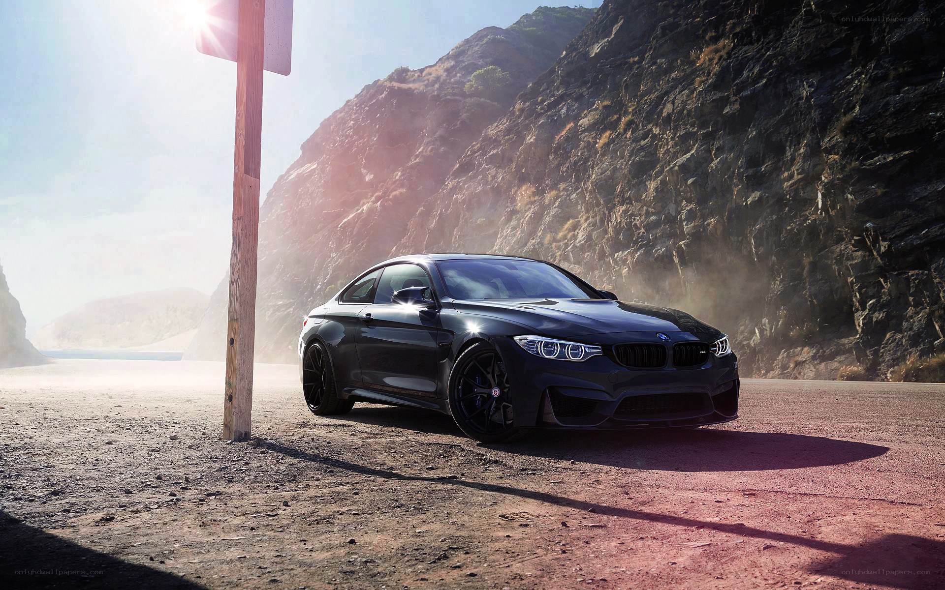 Black BMW M4 on a coastal road