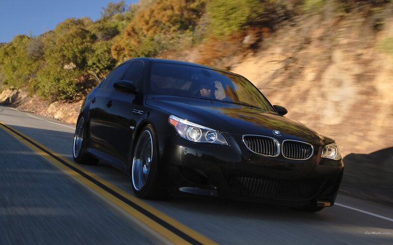 black bmw m5 driving on road